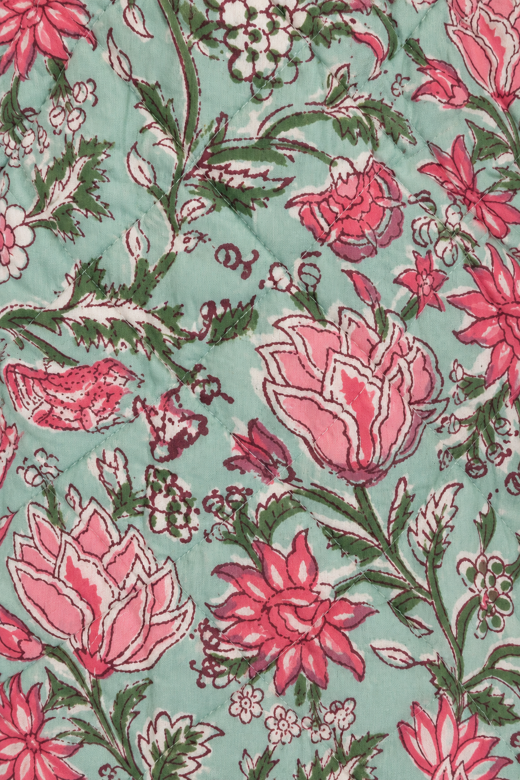 A close-up of a floral fabric pattern featuring pink and red flowers, green leaves, and small birds on a light mint green background.